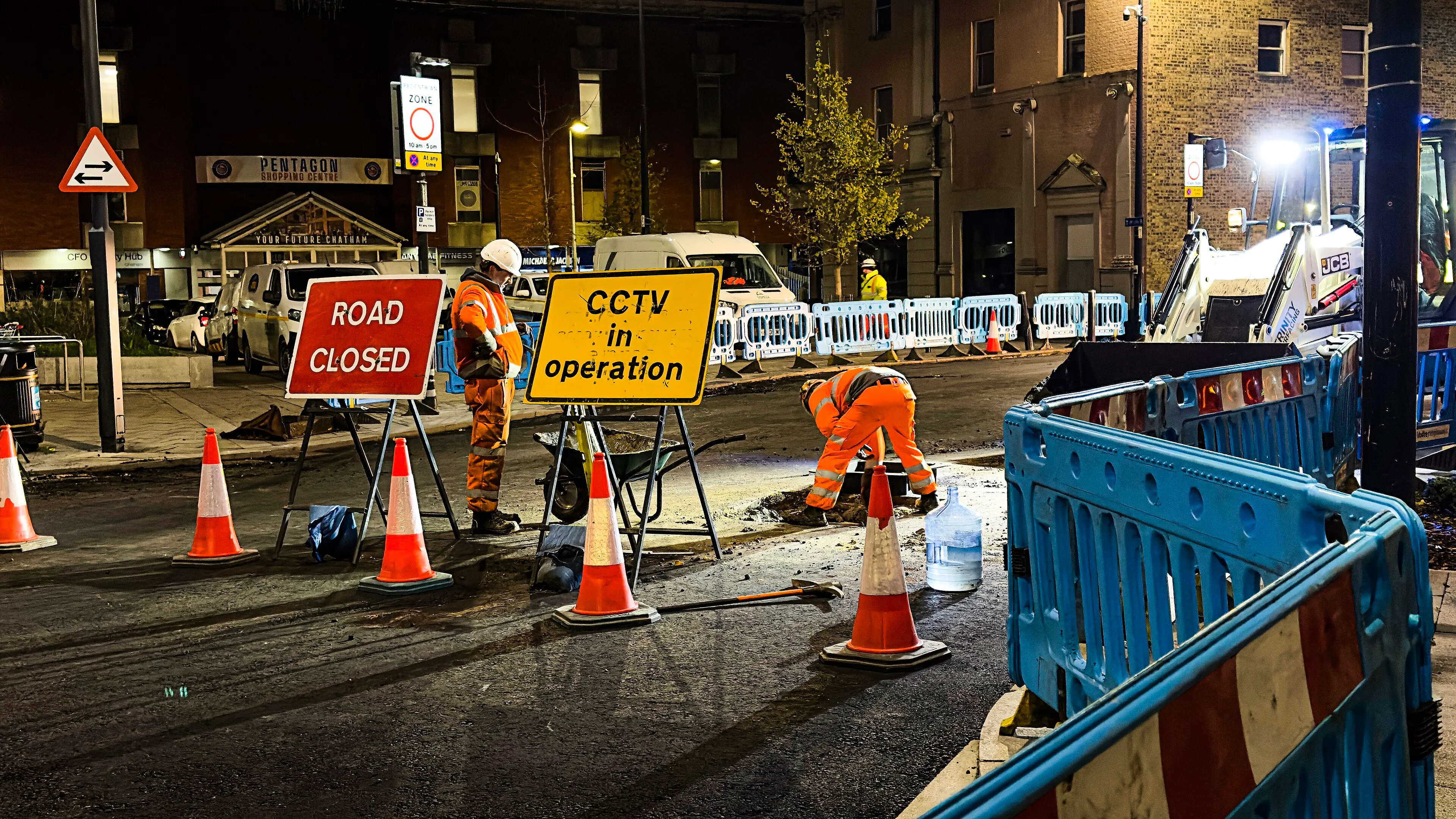 Night roadworks with road closed signs, cones and barriers